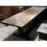 A large oak refectory table The rectangular plank top above twin turned supports,