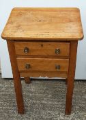 A Victorian pine two drawer bedside table