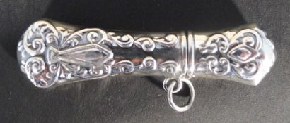 A small silver needle case