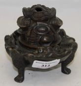 A bronze censor in the form of a frog