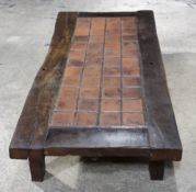 A large tile topped oak coffee table