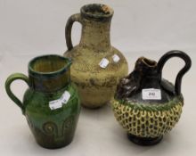 An unusual stoneware jug and two others