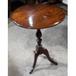 A 19th century elm top tripod table