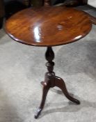 A 19th century elm top tripod table