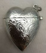 A silver embossed box in the shape of a heart