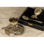 A cased silver egg cup and spoon,