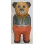 A carved wooden painted teddy bear