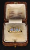 An 18 ct gold five stone opal set ring