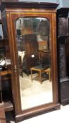 An Edwardian inlaid mahogany mirror door wardrobe