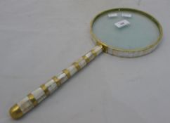 A large mother-of-pearl magnifying glass