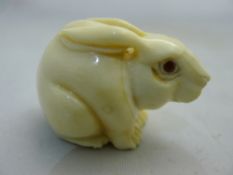 A bone netsuke in the form of a rabbit