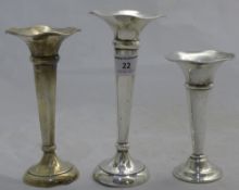 Two silver bud vases and a plated bud vase