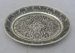 A Chinese oval white metal dish