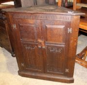 A Jack Grimble carved oak corner cupboard