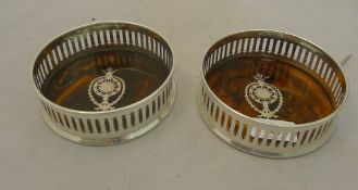 A pair of silver plated bottle coasters