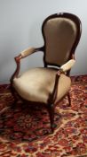 A Victorian upholstered mahogany framed open armchair