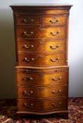 A 20th century mahogany serpentine chest on chest