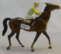 A Beswick brown racehorse with jockey up