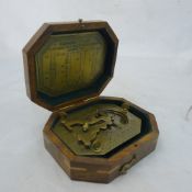 A cased brass sundial compass