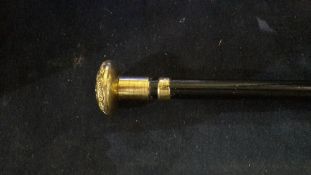 A gold plate mounted walking cane