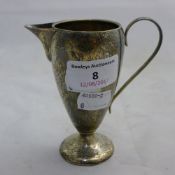 A silver cream jug