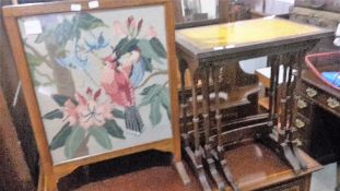 A 20th century nest of leather topped tables and a fire screen