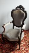 A Victorian upholstered mahogany open armchair