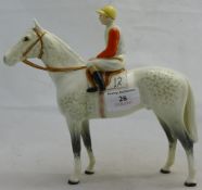 A Beswick dapple grey racehorse with jockey up