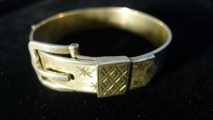 A silver buckle bangle