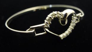 A silver heart bangle