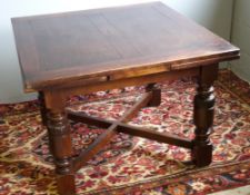 A large early 20th century oak drawer leaf table