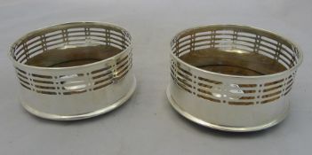 A pair of silver plated bottle coasters