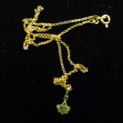 A 9 ct gold diamond and emerald pendant on a 9 ct gold chain