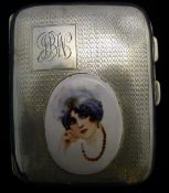 A silver cigarette case depicting a Deco style girl