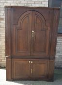 A large Georgian and later panel oak cupboard