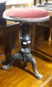 A Victorian piano stool with cast iron legs
