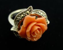 A silver and coral ring