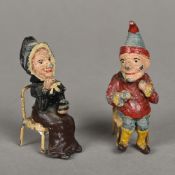 A pair of 19th century painted cast metal models of Punch and Judy Each modelled seated with a