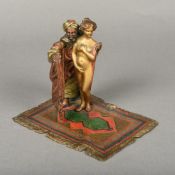 An erotic cold painted bronze group Worked as an Arab shrouding a young woman,