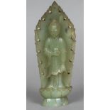 A Chinese carved green jade figure Modelled standing before a flaming Mandorla. 22.5 cm high.