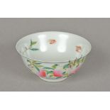 A Chinese porcelain bowl Decorated inside and out with bats amongst flowering peach trees,