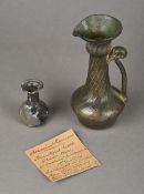 A small Roman glass vase, circa 1st century Together with a Roman glass ewer,