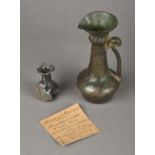 A small Roman glass vase, circa 1st century Together with a Roman glass ewer,