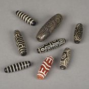 Eight various beads, possibly Tibetan Each of oval tubular form. The largest 7.25 cm long.