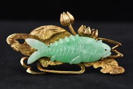 A Chinese 14K gold and jade brooch The carved jade carp amongst gold lilies and swirling water. 4.