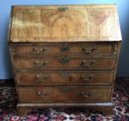 An 18th century George II/III walnut bureau The feather banded top above the feather banded fall