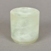 A small pale jade pot Of cylindrical form, with a tapering foot. 5.25 cm high.