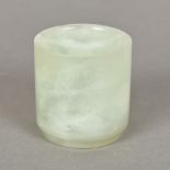 A small pale jade pot Of cylindrical form, with a tapering foot. 5.25 cm high.