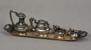 A silver miniature tea set and tray, hallmarked Birmingham 1972/1973,