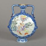 A Chinese porcelain moon vase Painted to either side with figural and deity filled vignettes,